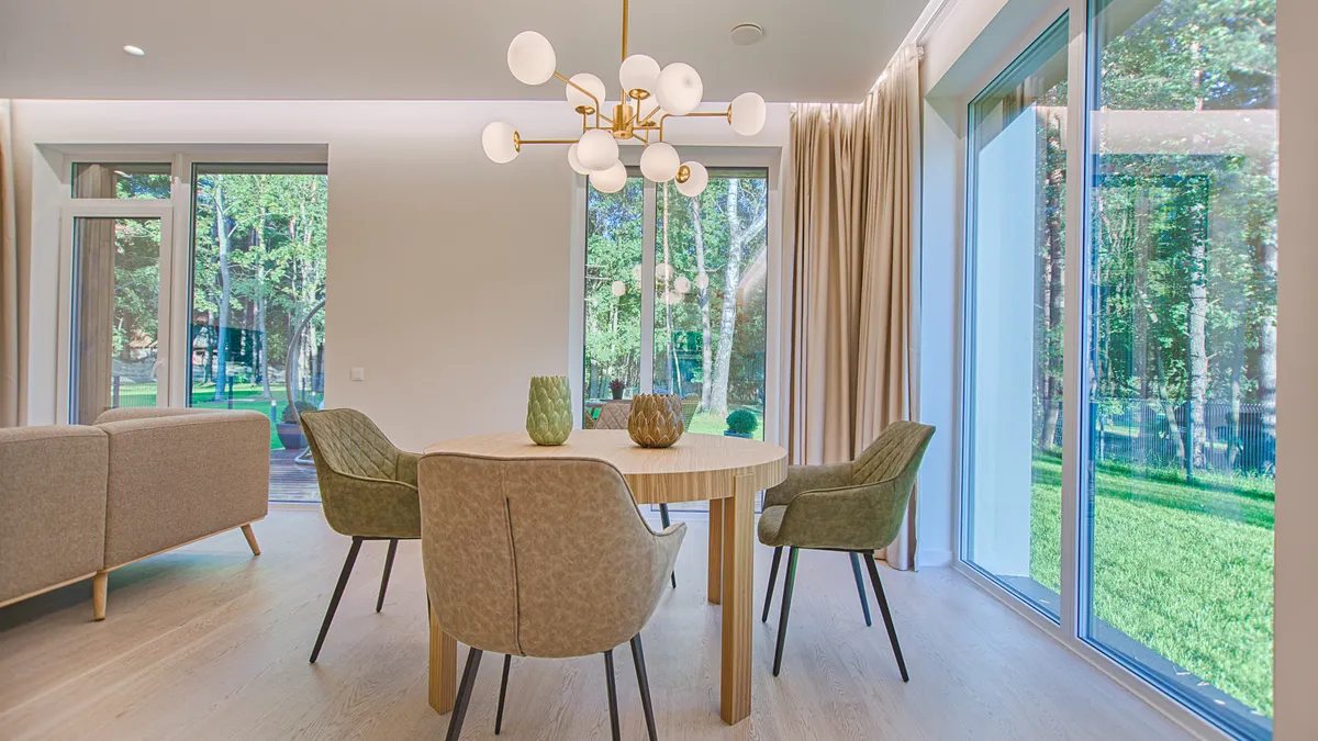 Styled interior room with patterned wall covering and natural light