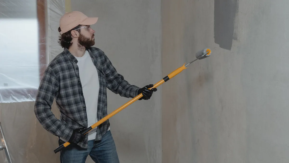 Worker cutting ceramic tile with a wet saw on a jobsite