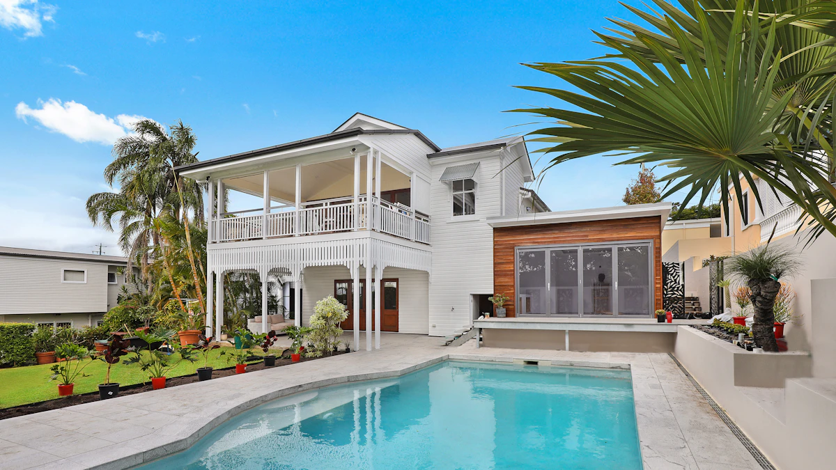 Freshly painted white two-story house with tidy landscaping