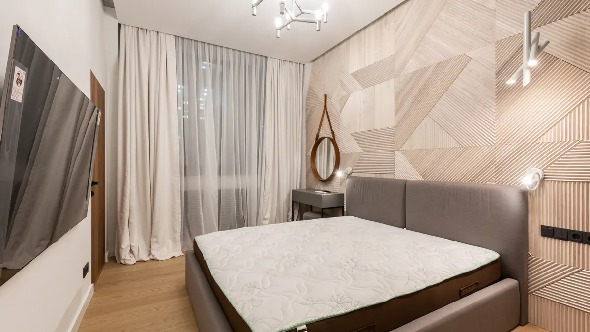 Bright converted living space with large windows and modern furnishings