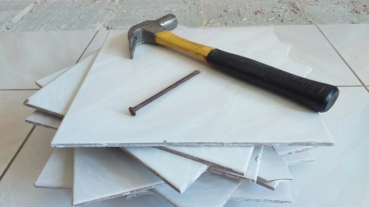 Stack of ceramic floor tiles with a hammer on a tiled surface