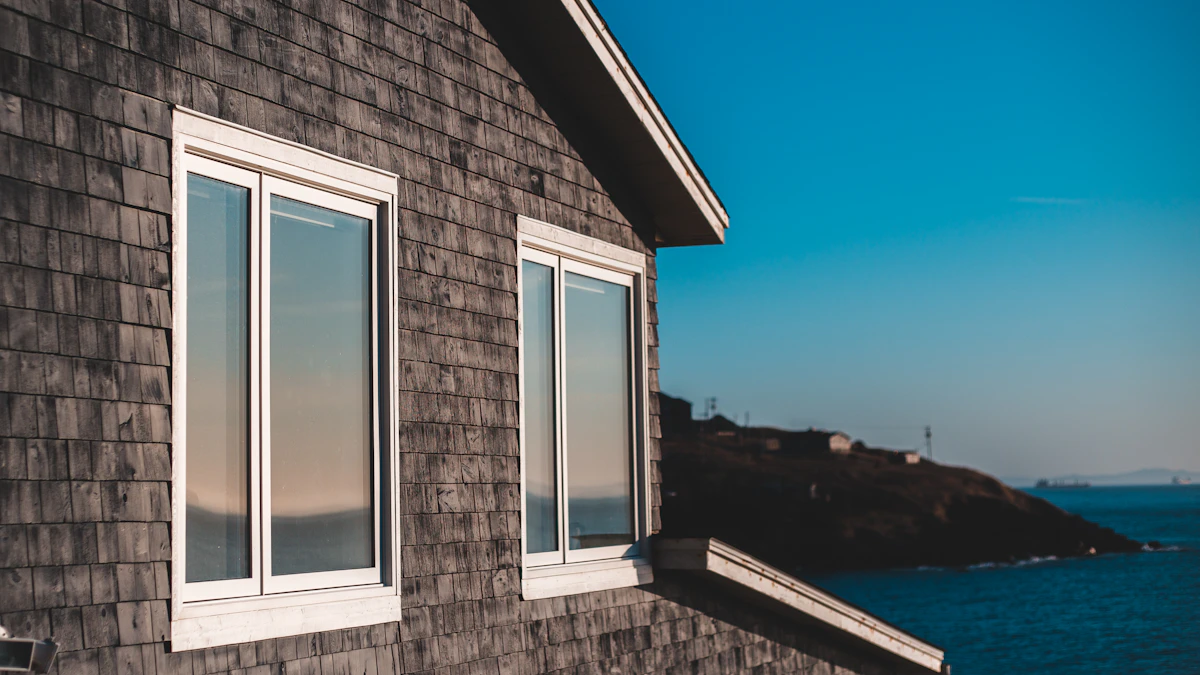 White replacement windows on a home with gray shingle siding
