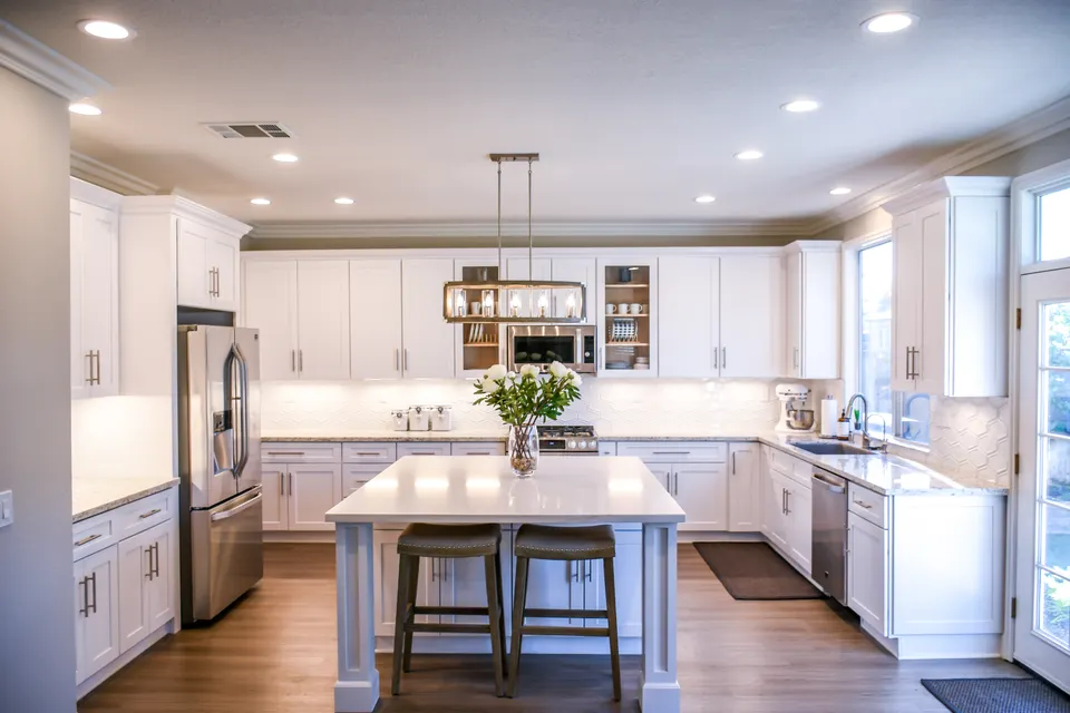 White kitchen cabinets and island during a full remodel