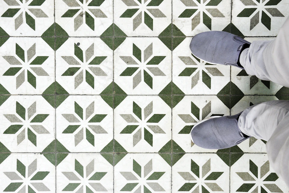 Decorative patterned floor tiles installed in a geometric layout