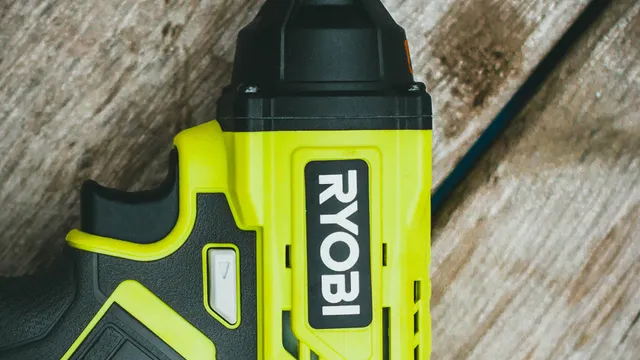 Close-up of a cordless drill on a wooden workbench